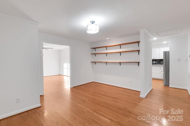 2750 Morgan Rd, Gold Hill, NC 28071 - unfurnished room featuring baseboards, light wood-style floors, and crown molding