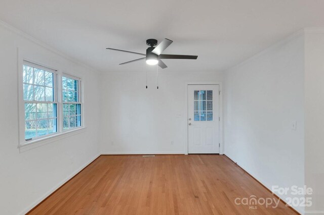 2750 Morgan Rd, Gold Hill, NC 28071 - spare room featuring light wood-style flooring, a ceiling fan, baseboards, and ornamental molding