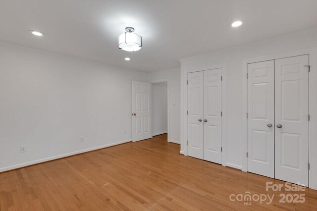 2750 Morgan Rd, Gold Hill, NC 28071 - unfurnished bedroom featuring recessed lighting, baseboards, two closets, and light wood finished floors