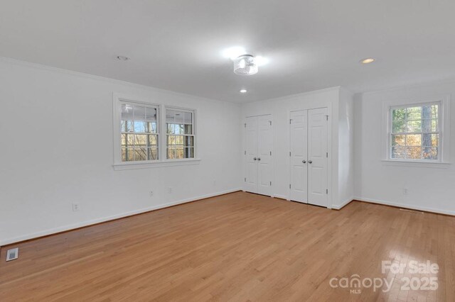 2750 Morgan Rd, Gold Hill, NC 28071 - unfurnished bedroom featuring ornamental molding, wood finished floors, multiple closets, and baseboards
