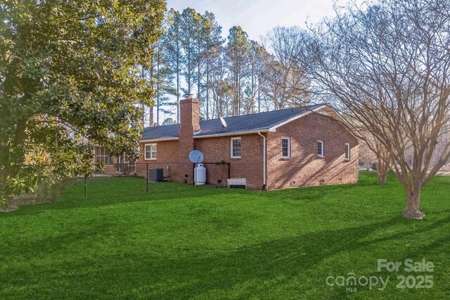 2750 Morgan Rd, Gold Hill, NC 28071 - back of property featuring a lawn, central AC, crawl space, brick siding, and a chimney