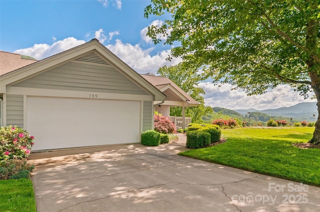 135 Oakcrest Ln, Waynesville, NC 28786 - ranch-style home featuring a front yard, a mountain view, driveway, a garage, and roof with shingles