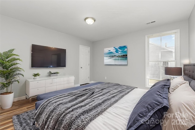 201 Tuckaseege Rd, Mount Holly, NC 28120 - bedroom featuring wood finished floors, visible vents, and baseboards
