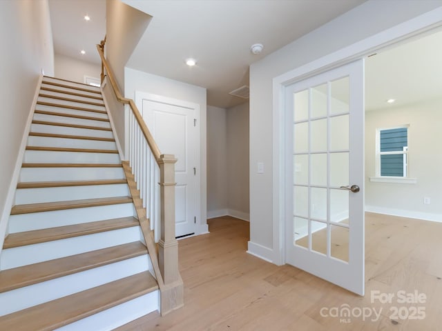 stairs featuring recessed lighting, wood finished floors, and baseboards