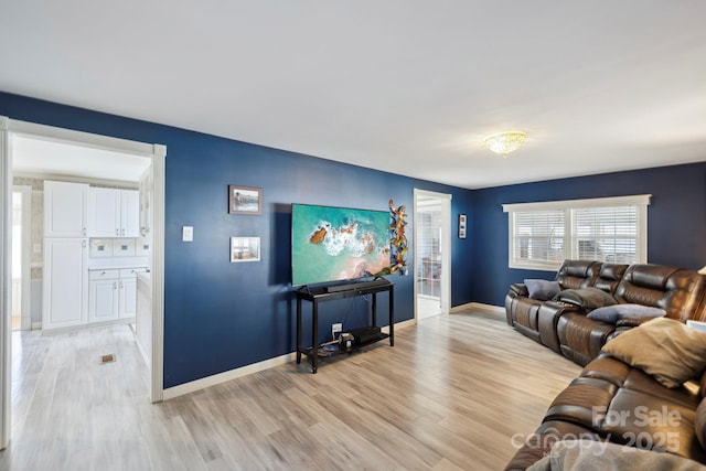 living area with light wood finished floors and baseboards