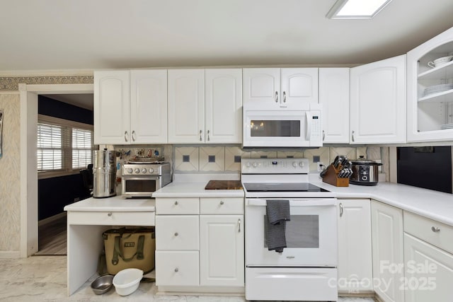 kitchen with white cabinetry, light countertops, marble finish floor, and white appliances