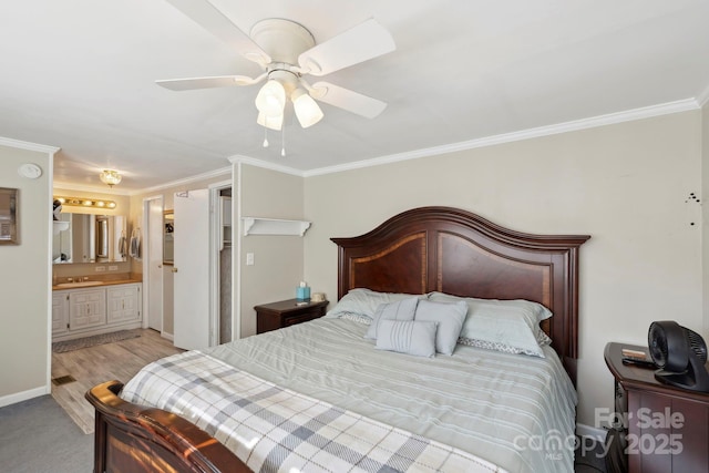 bedroom with baseboards, ornamental molding, ceiling fan, connected bathroom, and a sink
