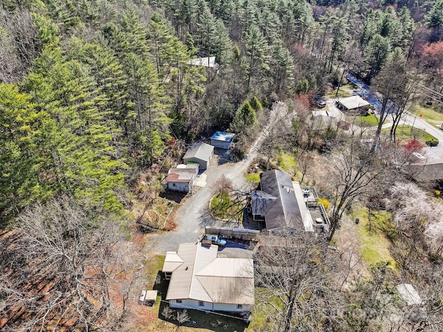 birds eye view of property featuring a view of trees