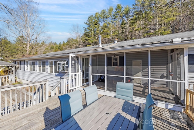 wooden deck featuring a sunroom