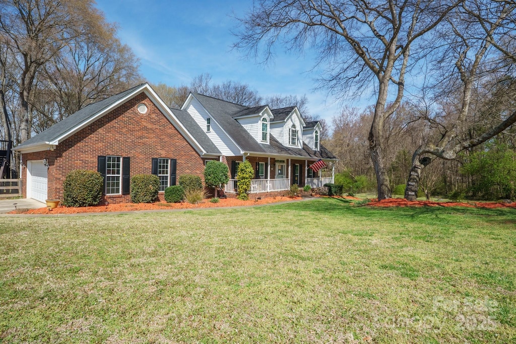 4436 Roberta Rd, Concord, NC 28027 - view of front facade featuring brick siding, a porch, a front lawn, and a garage