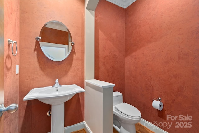 half bath featuring wood finished floors and toilet