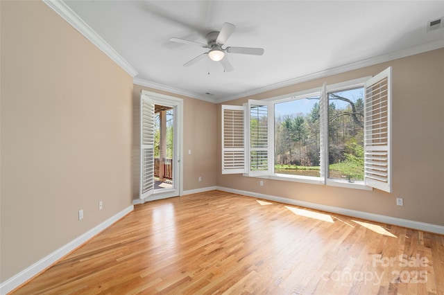 unfurnished room featuring light wood-style floors, baseboards, and ornamental molding