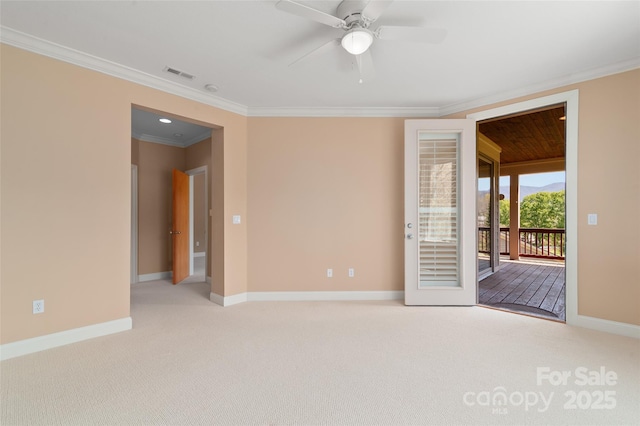 spare room with visible vents, crown molding, baseboards, light colored carpet, and ceiling fan