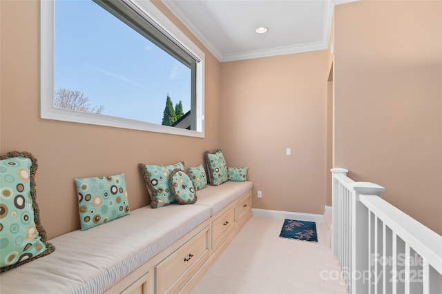 living area with light colored carpet, baseboards, ornamental molding, and an upstairs landing