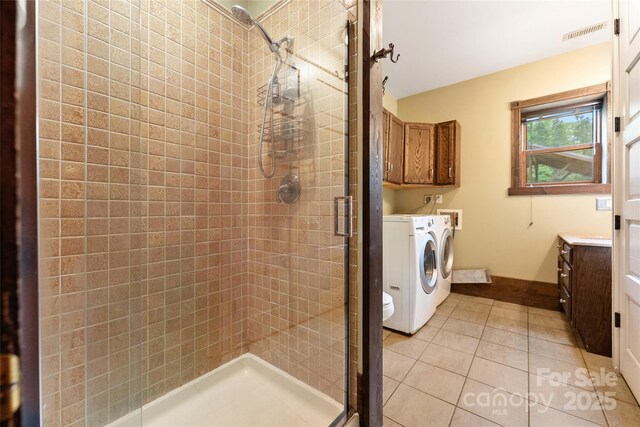 731 Old Fort Rd, Fairview, NC 28730 - bathroom featuring separate washer and dryer, a shower stall, baseboards, and tile patterned floors
