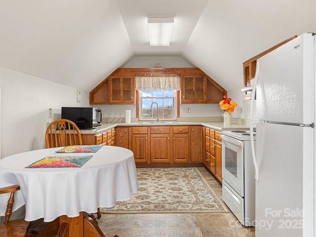 727 Jenkins Valley Rd, Alexander, NC 28701 - kitchen featuring white appliances, brown cabinetry, light countertops, a sink, and lofted ceiling