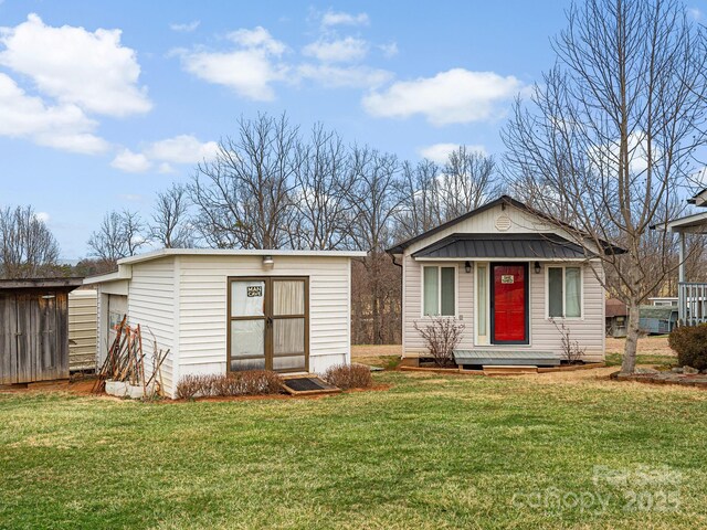 727 Jenkins Valley Rd, Alexander, NC 28701 - view of front facade featuring an outbuilding, a front lawn, and metal roof