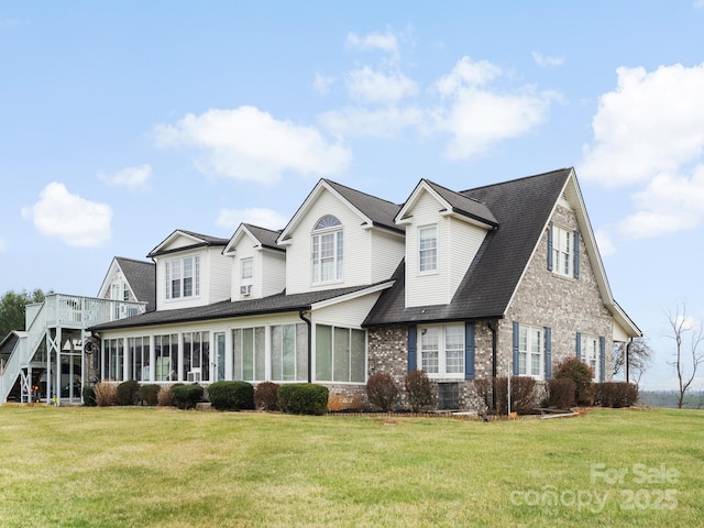 727 Jenkins Valley Rd, Alexander, NC 28701 - view of front of home with brick siding, a front yard, roof with shingles, and a sunroom