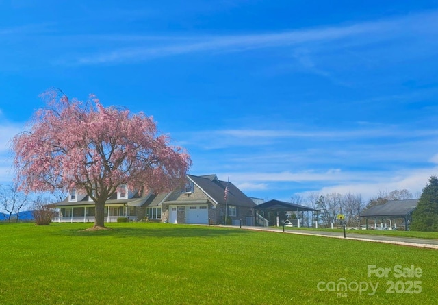 727 Jenkins Valley Rd, Alexander, NC 28701 - view of front facade with concrete driveway, a front yard, a carport, and an attached garage
