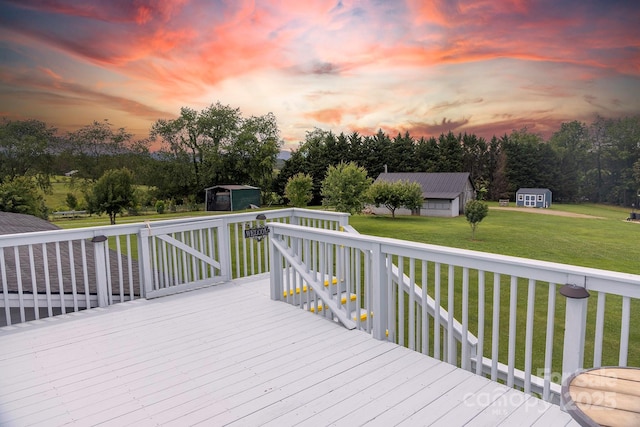 727 Jenkins Valley Rd, Alexander, NC 28701 - deck at dusk featuring a shed, a yard, and view of wooded area