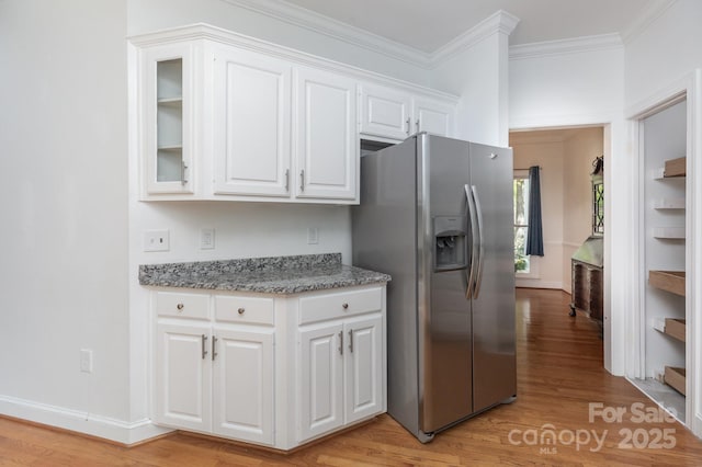 kitchen featuring light wood-type flooring, ornamental molding, white cabinetry, and stainless steel fridge with ice dispenser