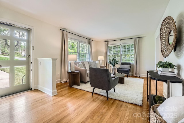 living area featuring light wood-type flooring and baseboards