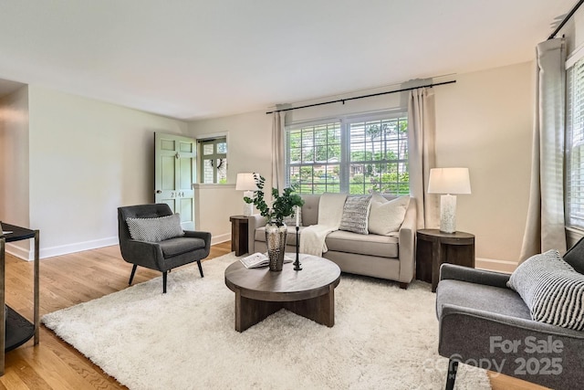 living room featuring baseboards and light wood finished floors