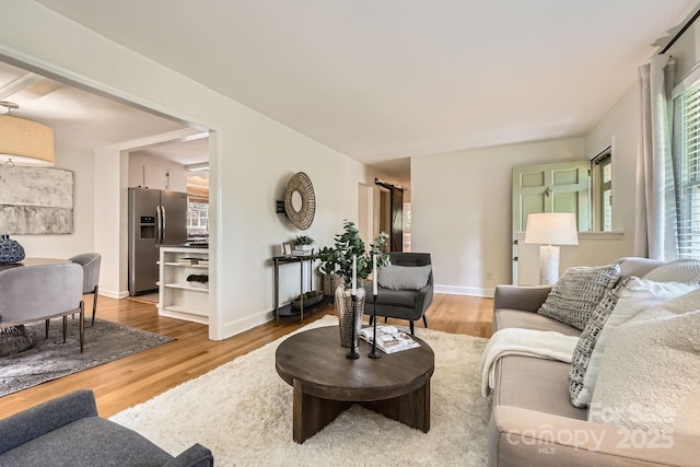 living room with baseboards and wood finished floors