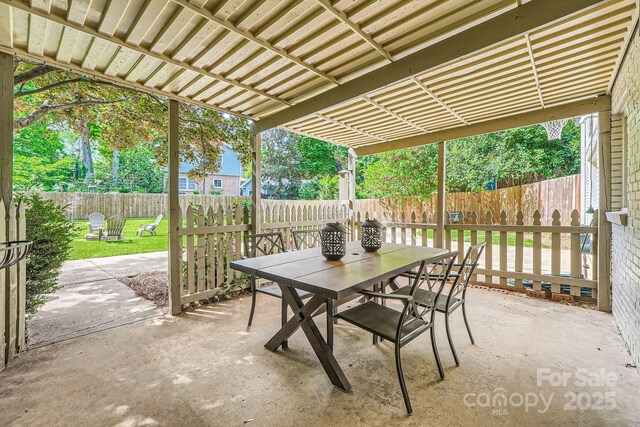 view of patio with outdoor dining space and a fenced backyard
