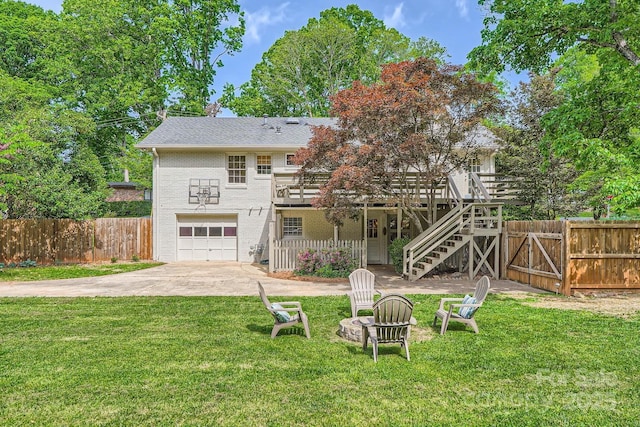 rear view of house with fence, a garage, brick siding, stairway, and a deck