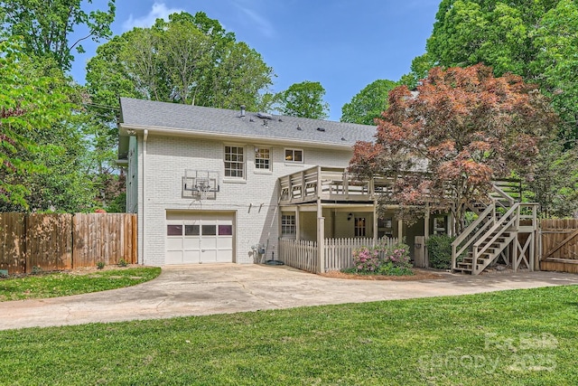 view of front of home with fence, a front lawn, driveway, brick siding, and a garage