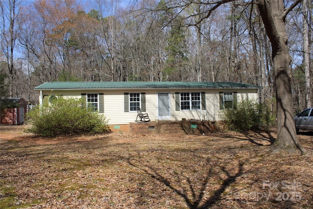 7597 Webbs Rd, Denver, NC 28037 - view of front of property featuring crawl space, metal roof, a storage unit, and an outbuilding