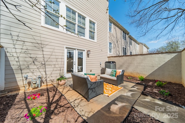 view of patio / terrace featuring french doors, an outdoor hangout area, and fence