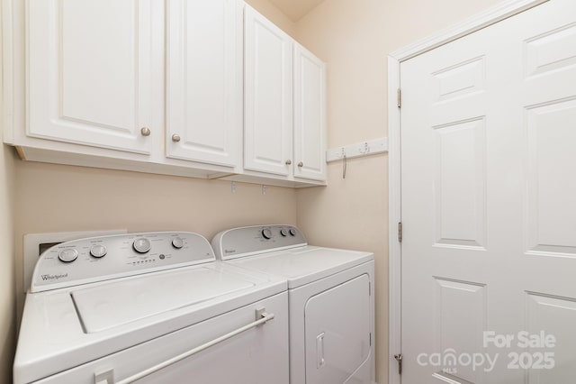 washroom featuring independent washer and dryer and cabinet space