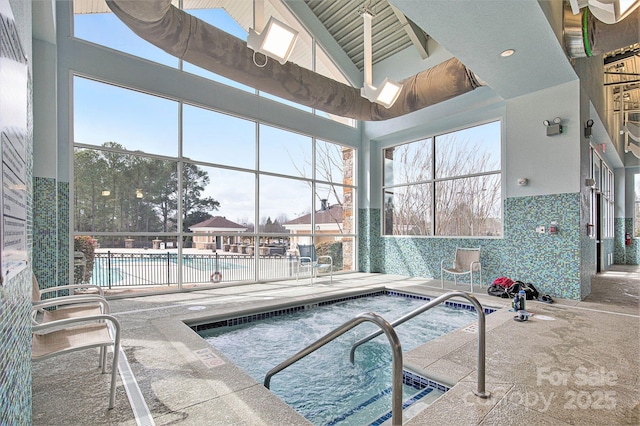 view of pool with an indoor hot tub