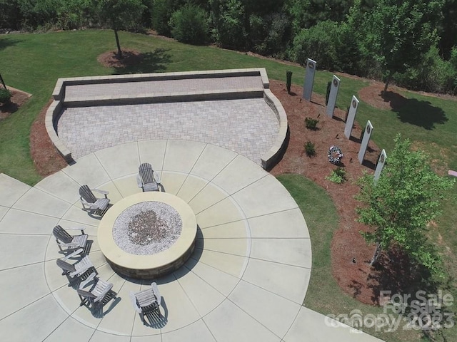 view of property's community with a patio area and a lawn