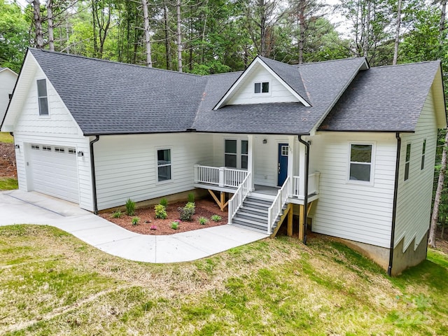 605 Knob Rd, Pisgah Forest, NC 28768 - view of front of house with roof with shingles, a porch, a front lawn, driveway, and view of scattered trees