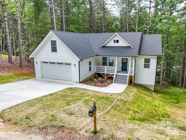 605 Knob Rd, Pisgah Forest, NC 28768 - view of front of home with a porch, a shingled roof, driveway, and a front lawn