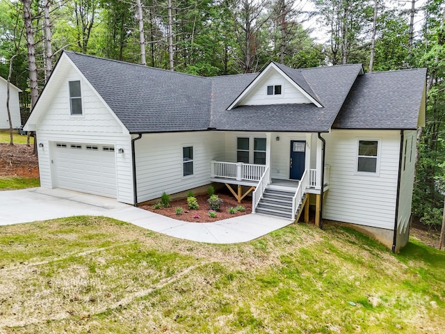 605 Knob Rd, Pisgah Forest, NC 28768 - view of front facade with a shingled roof, a porch, a front lawn, driveway, and view of wooded area