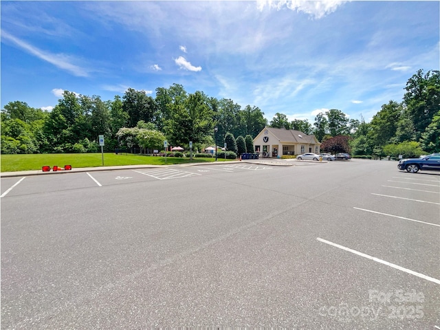 8212 Merryvale Ln, Charlotte, NC 28214 - uncovered parking lot featuring view of scattered trees