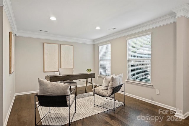 office featuring baseboards, wood finished floors, visible vents, and ornamental molding