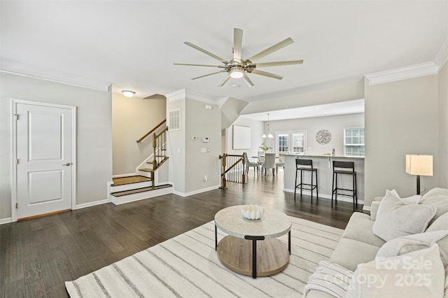 living area featuring stairway, wood finished floors, visible vents, and ceiling fan