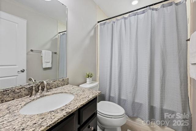 full bath with toilet, vanity, and shower / bath combo