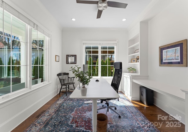office space with wood finished floors, built in shelves, ceiling fan, and a healthy amount of sunlight