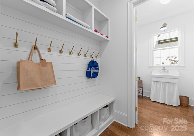 mudroom with baseboards and wood finished floors