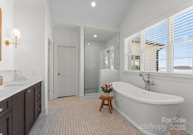 full bath featuring tile patterned floors, a stall shower, vanity, a soaking tub, and recessed lighting