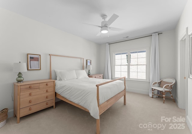 bedroom featuring baseboards, a ceiling fan, and light colored carpet