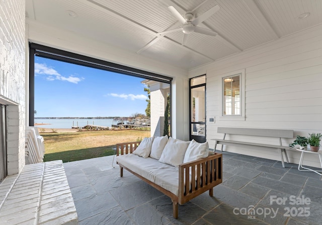 sunroom / solarium featuring an outdoor hangout area, a water view, and ceiling fan