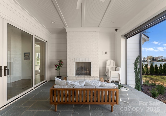 sunroom featuring a water view