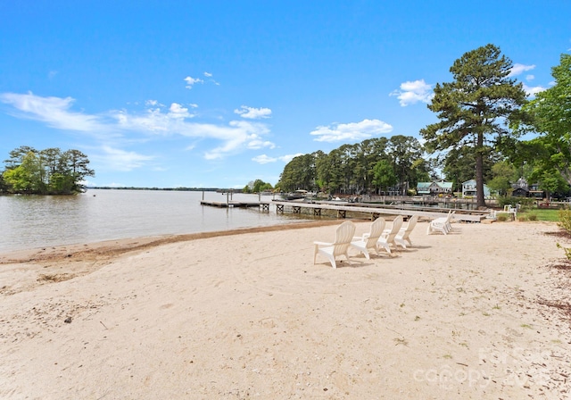 view of property's community featuring a water view and a boat dock